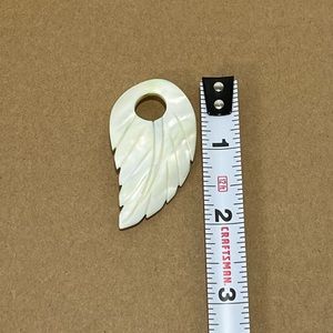 Mother of pearl leaf. Has hole cut into it. Ready for most necklaces.